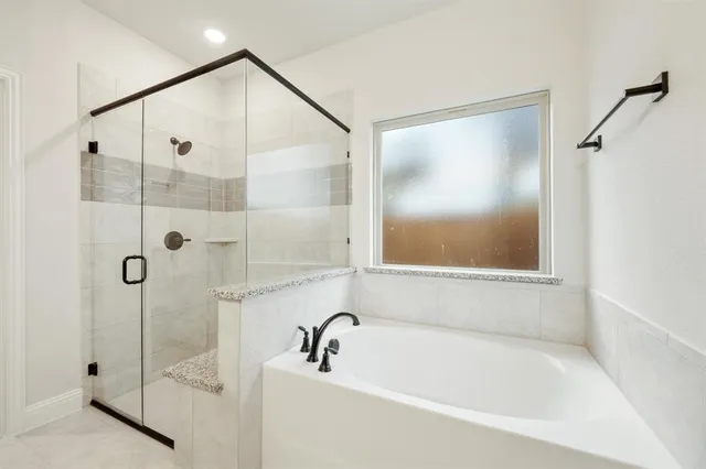 a bathroom with a bathtub and a shower