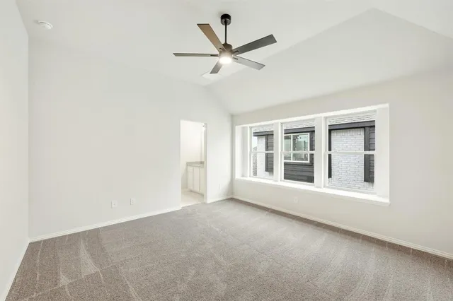 an empty room with a ceiling fan and window