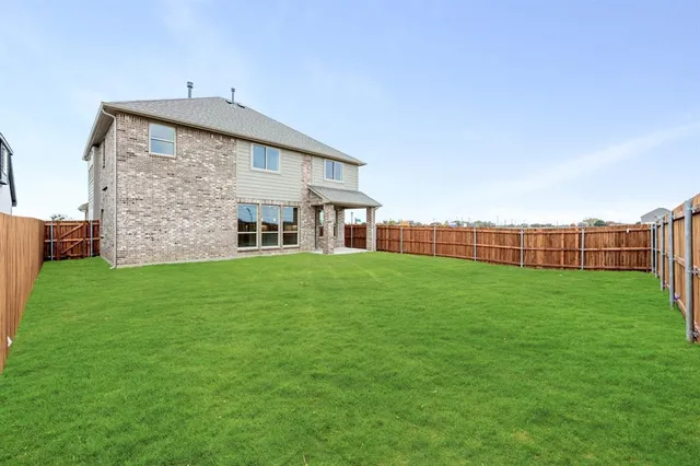 a view of a house with a yard and sitting area