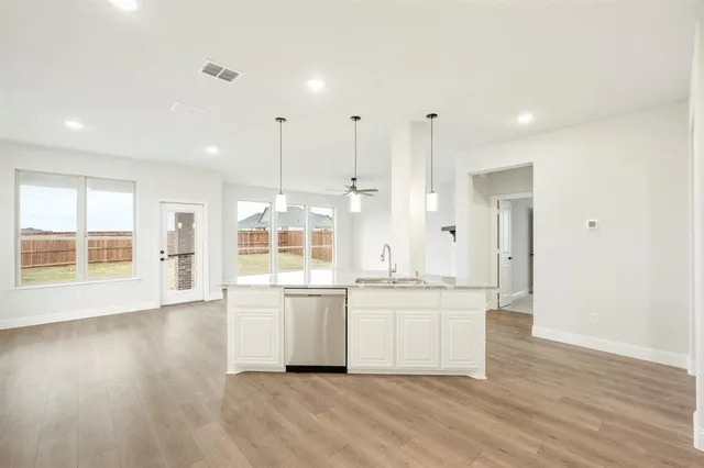 a large white kitchen with a large window