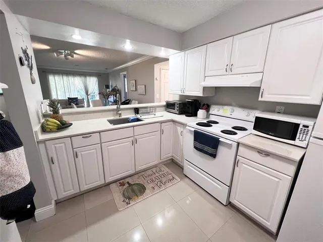 a kitchen that has a sink and a stove in it