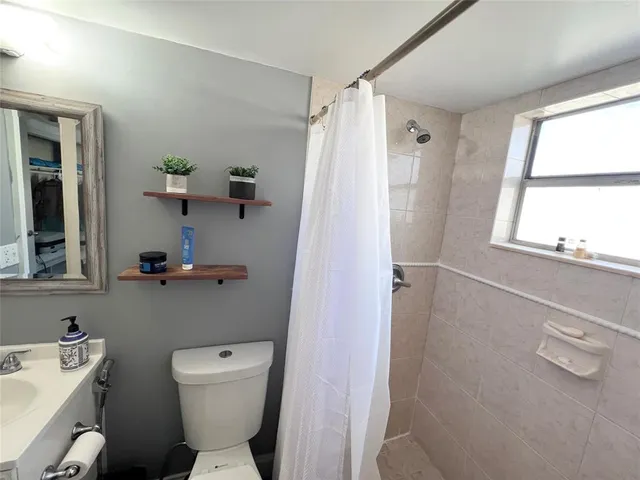 a bathroom with a toilet a sink and tub