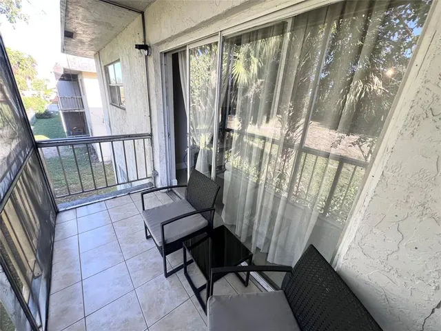 a view of a porch with a floor to ceiling window