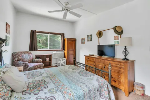 a bedroom with a bed and a flat screen tv