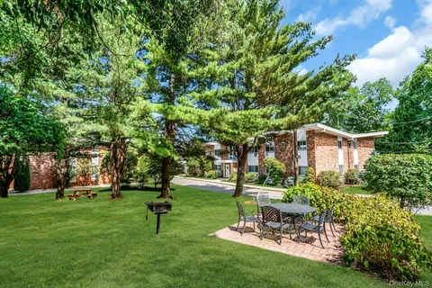 a garden with trees in the background