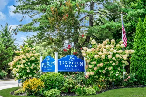 a sign that is sitting in front of flowers
