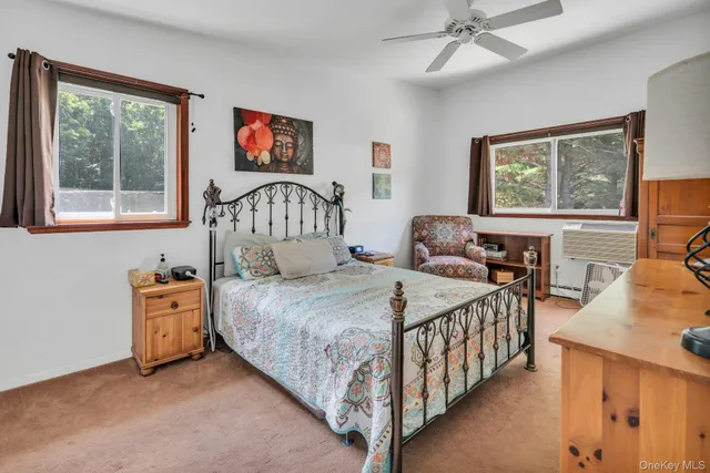 a bedroom with a bed and a large window