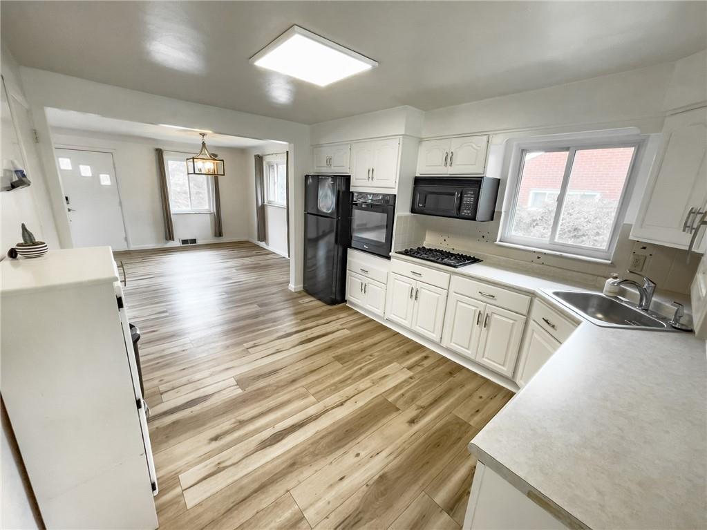 411 Colonial Drive Monroeville, PA 15146 - Photo 13 of 39 a large white kitchen with cabinets and wooden floor