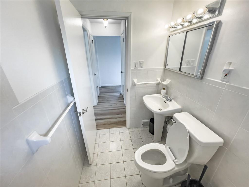 411 Colonial Drive Monroeville, PA 15146 - Photo 22 of 39 a bathroom with a sink a mirror a toilet and a mirror