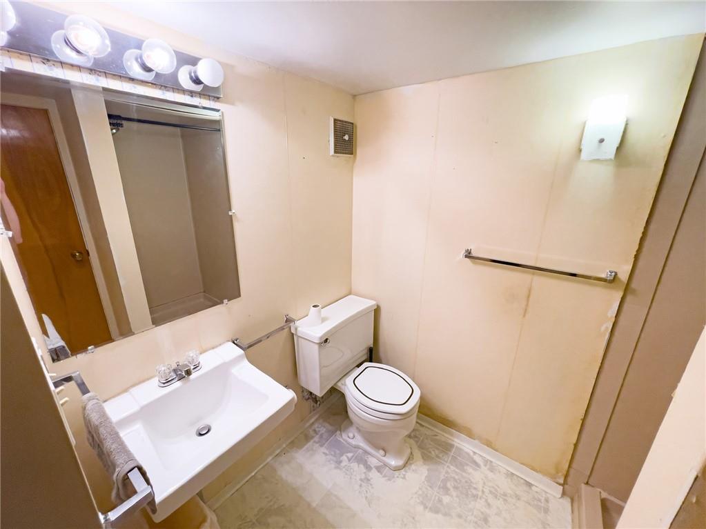 411 Colonial Drive Monroeville, PA 15146 - Photo 27 of 39 a white toilet sitting next to a bathroom sink