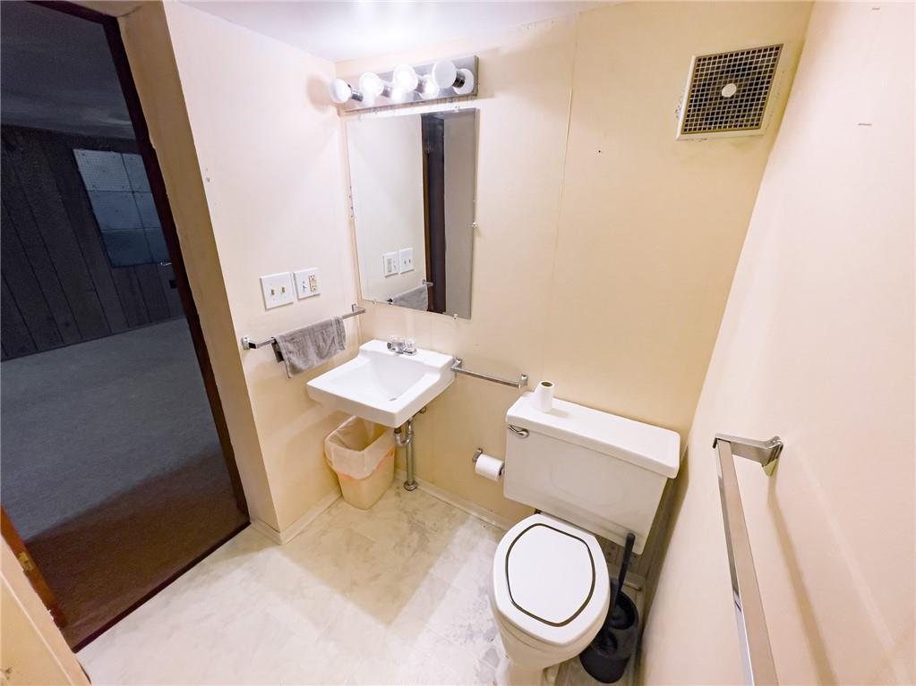 411 Colonial Drive Monroeville, PA 15146 - Photo 28 of 39 a bathroom with a toilet a sink and a mirror