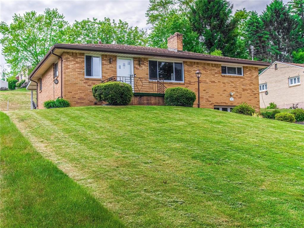 411 Colonial Drive Monroeville, PA 15146 - Photo 3 of 39 a view of a backyard with plants and large tree