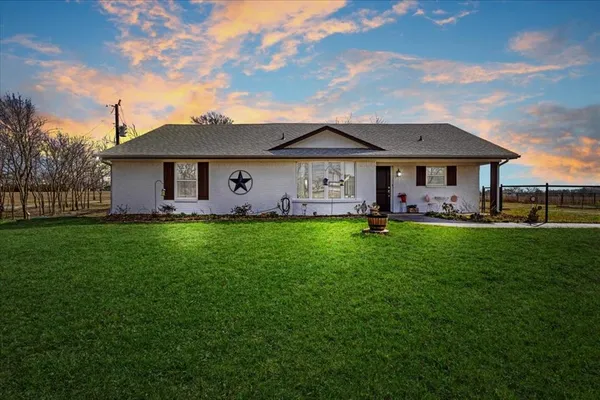 a front view of house with yard and green space