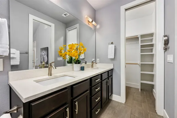 a bathroom with a sink double vanity and a mirror