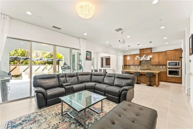 a living room with furniture kitchen and a large window