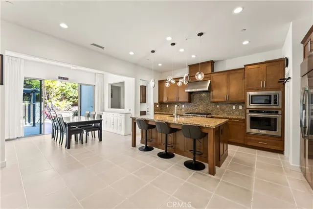 a large kitchen with lots of counter space and furniture