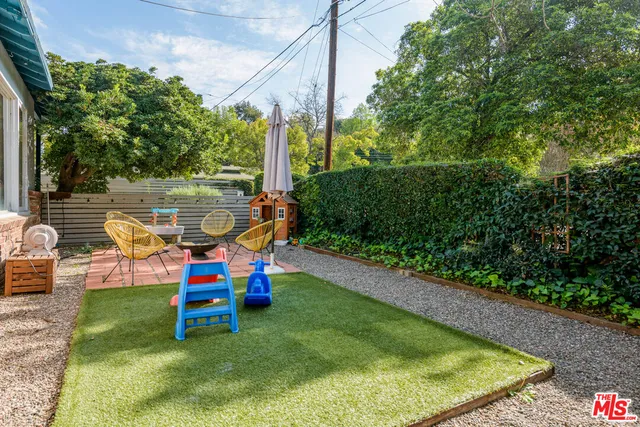 a backyard of a house with outdoor seating