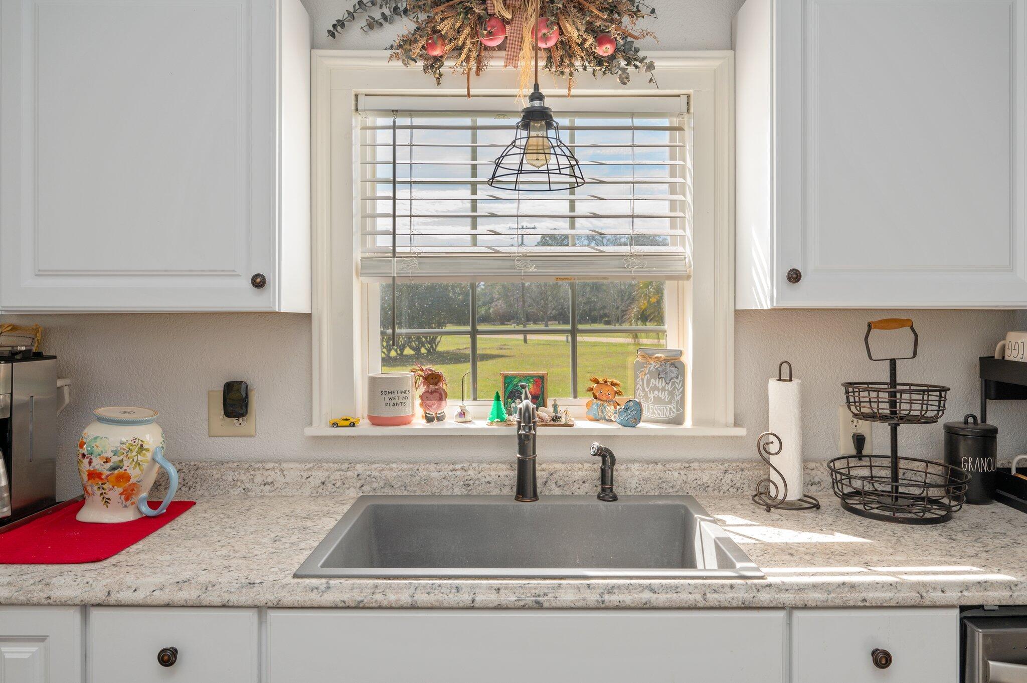 2288 Caton Road Florala, AL 36442 - Photo 8 of 47 a kitchen with granite countertop a sink and a window