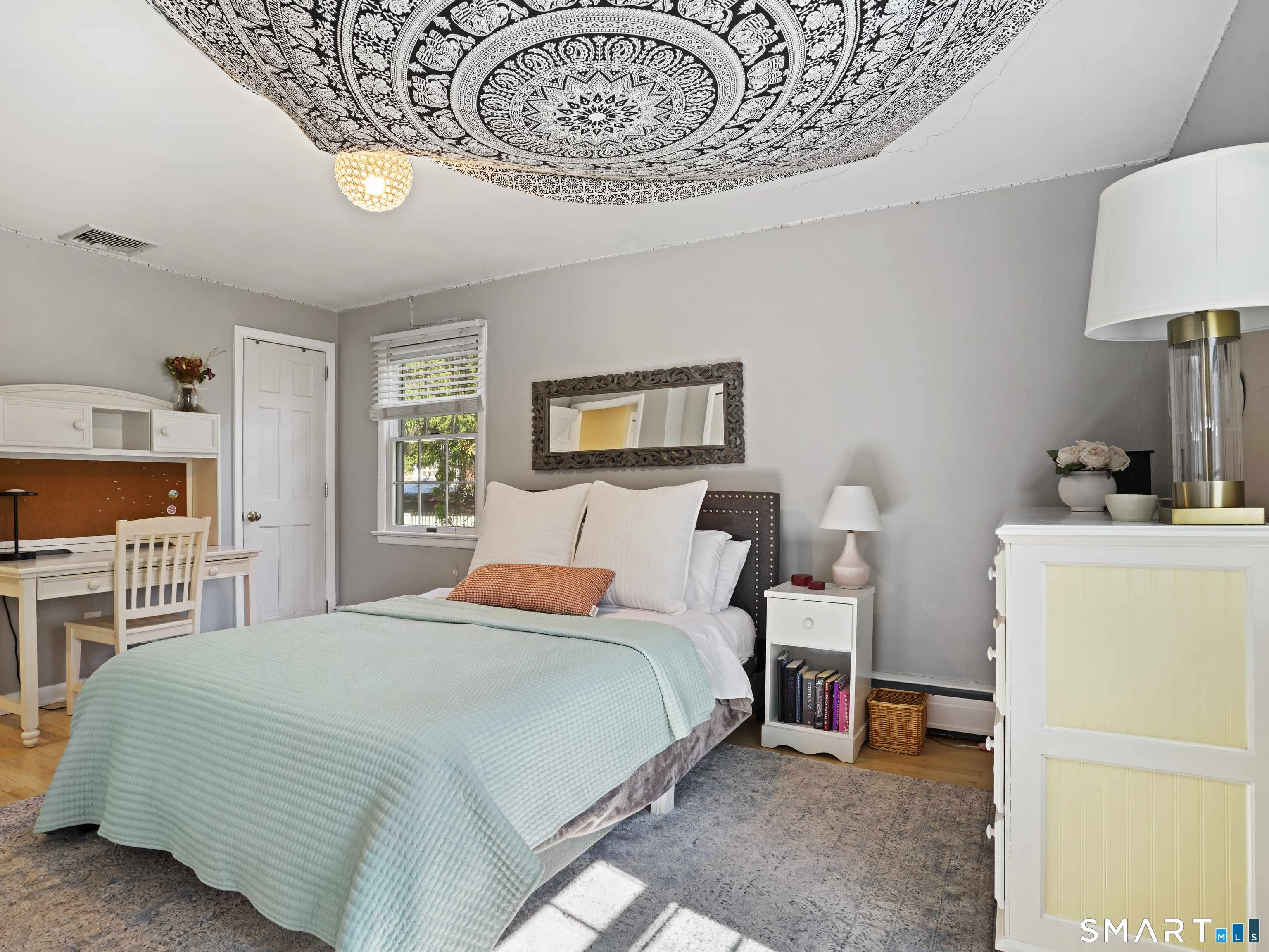 10 Reimer Road Westport, CT 06880 - Photo 19 of 38 a bedroom with a bed and a chandelier