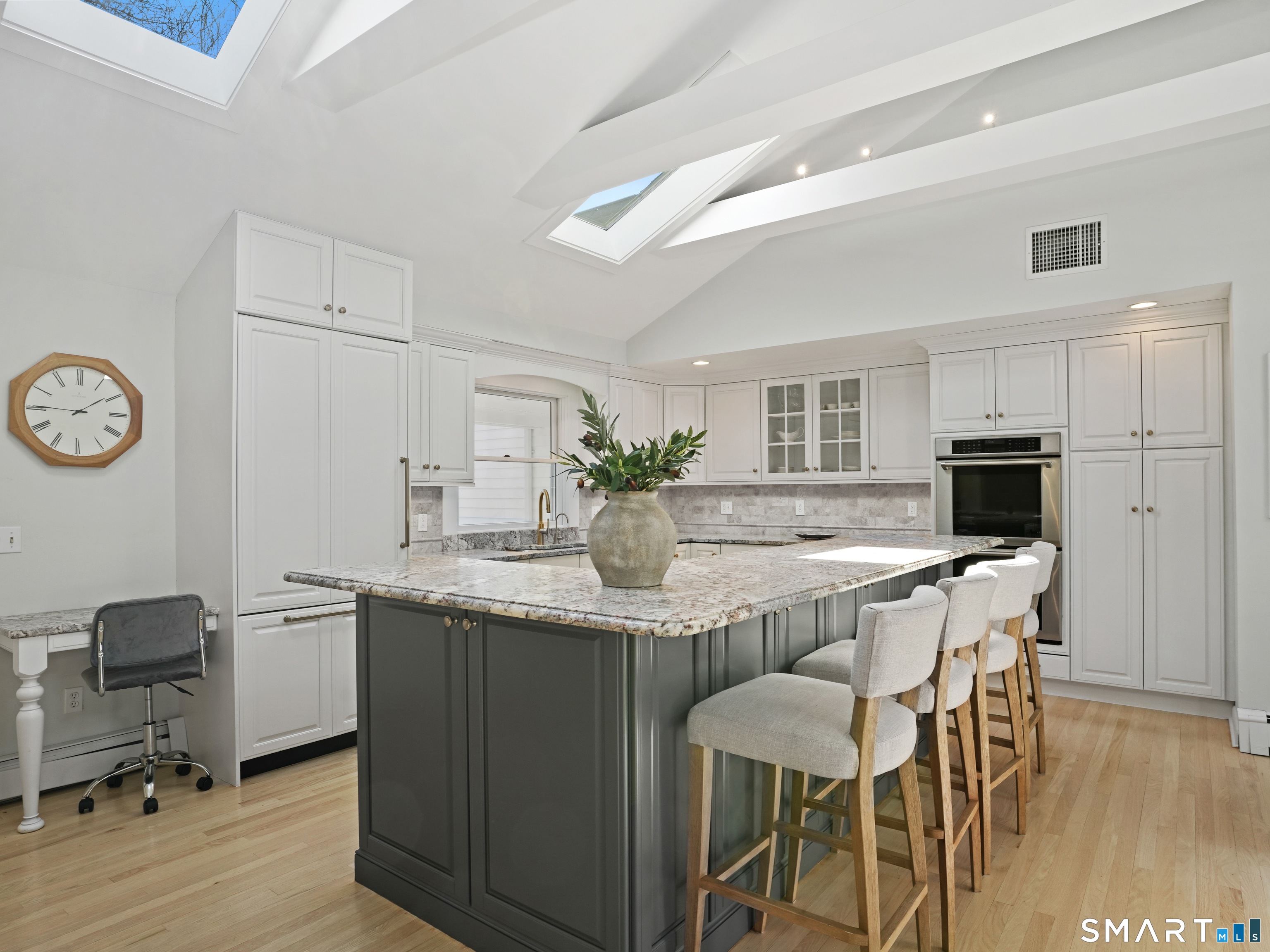 10 Reimer Road Westport, CT 06880 - Photo 3 of 38 a dining room with kitchen island a table and chairs in it