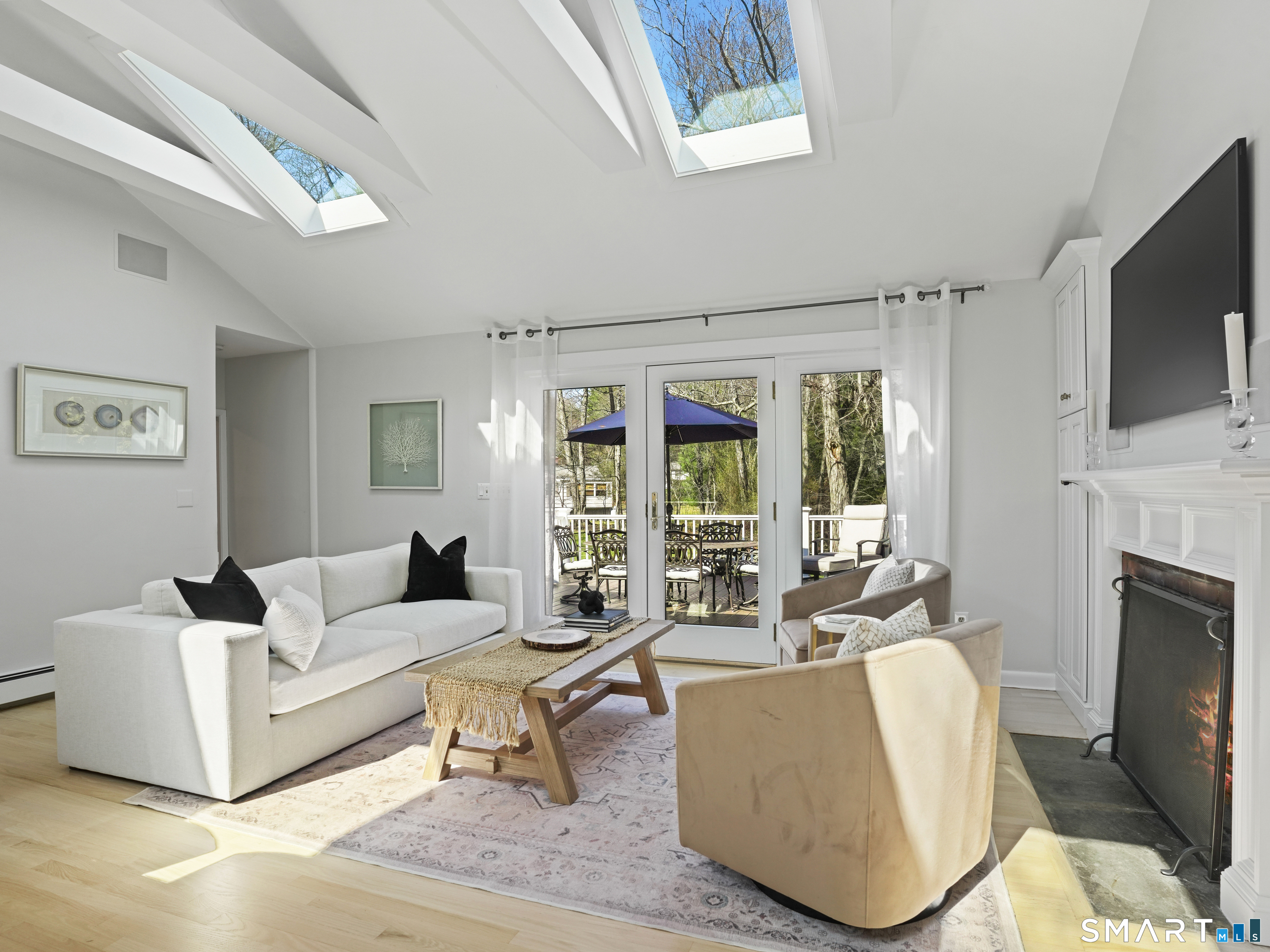 10 Reimer Road Westport, CT 06880 - Photo 6 of 38 a living room with furniture a fireplace and a flat screen tv