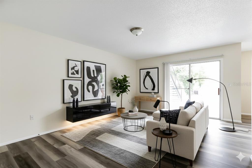 5317 Curry Ford Road, Unit J102 Orlando, FL 32812 - Photo 13 of 24 a living room with furniture and a large window