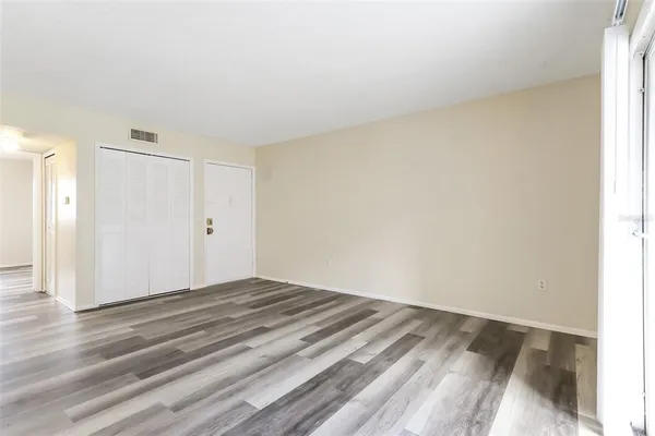 a view of a livingroom with wooden floor and closet