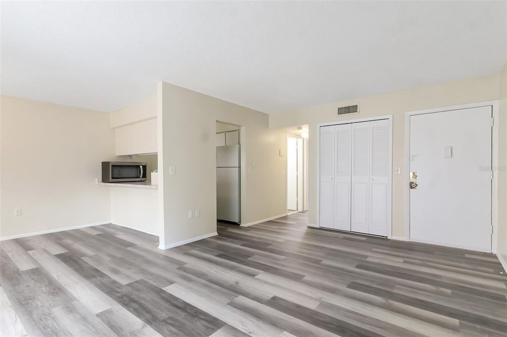 5317 Curry Ford Road, Unit J102 Orlando, FL 32812 - Photo 15 of 24 a view of a livingroom with wooden floor and closet