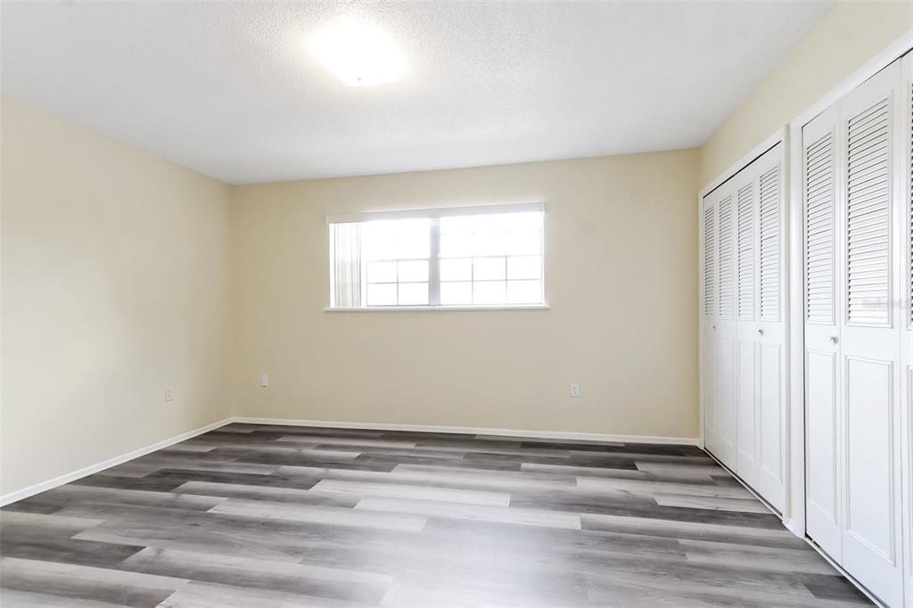 5317 Curry Ford Road, Unit J102 Orlando, FL 32812 - Photo 19 of 24 a view of a room with wooden floor and window
