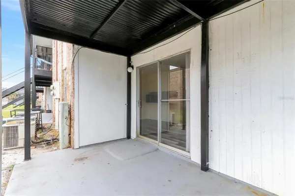 a view of a porch with a table and chairs