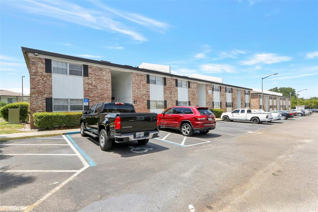 5317 Curry Ford Road, Unit J102 Orlando, FL 32812 - Photo 3 of 24 a car parked in front of a house