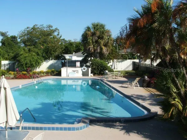 a view of a swimming pool with a yard