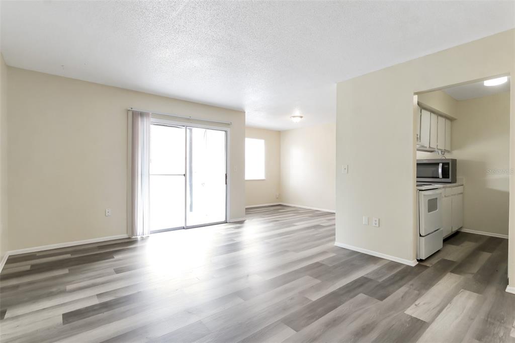 5317 Curry Ford Road, Unit J102 Orlando, FL 32812 - Photo 10 of 24 a view of empty room with wooden floor and window