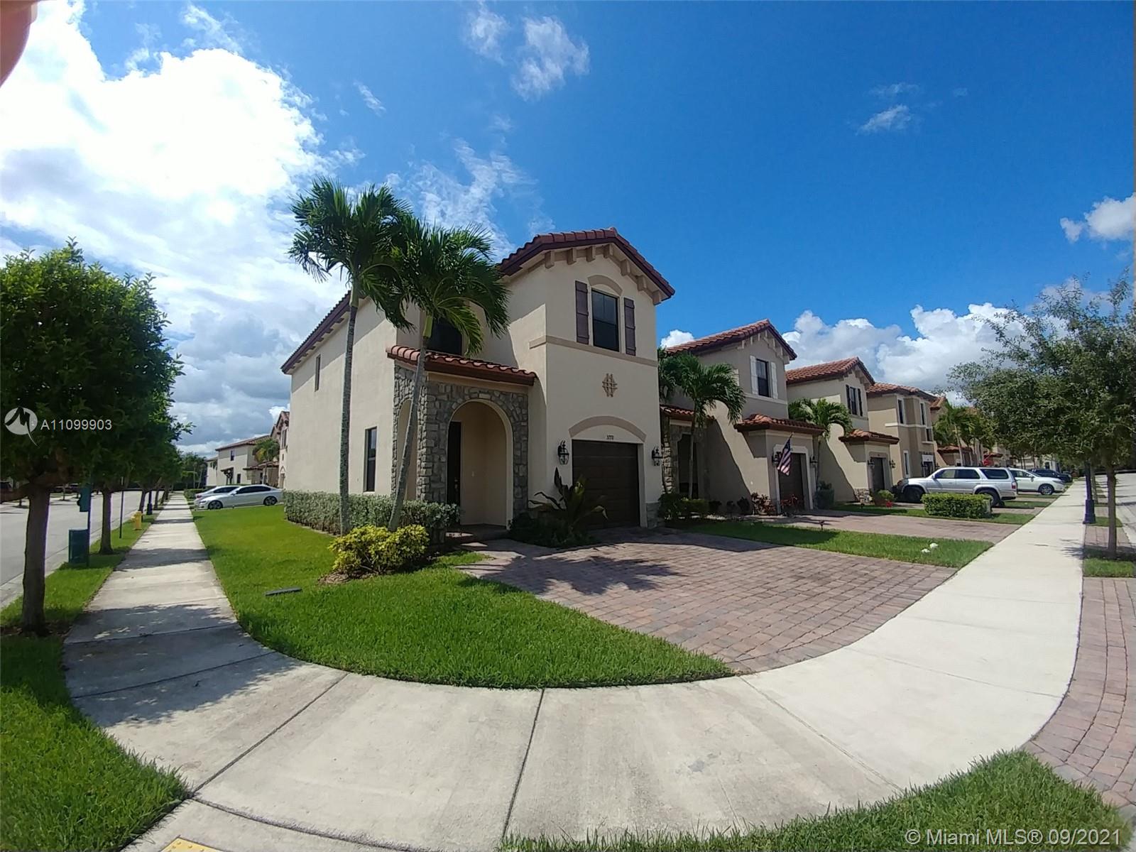3778 Northeast 2nd Street Homestead, FL 33033 - Photo 2 of 15 a front view of a house with a yard and garage