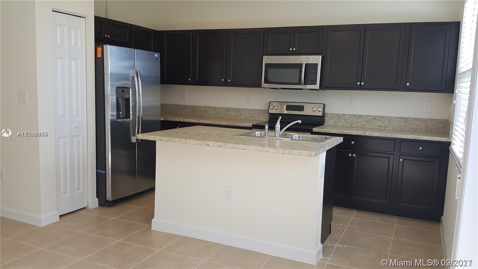 3778 Northeast 2nd Street Homestead, FL 33033 - Photo 11 of 15 a kitchen with a sink and a microwave