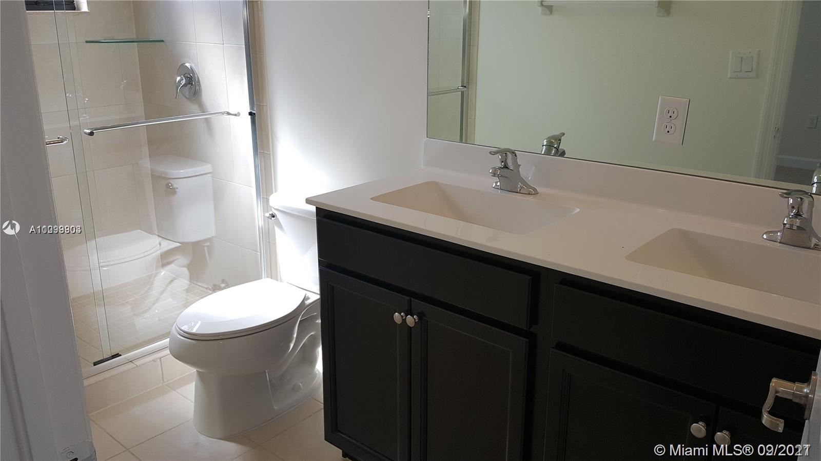 3778 Northeast 2nd Street Homestead, FL 33033 - Photo 14 of 15 a bathroom with a sink a toilet and shower