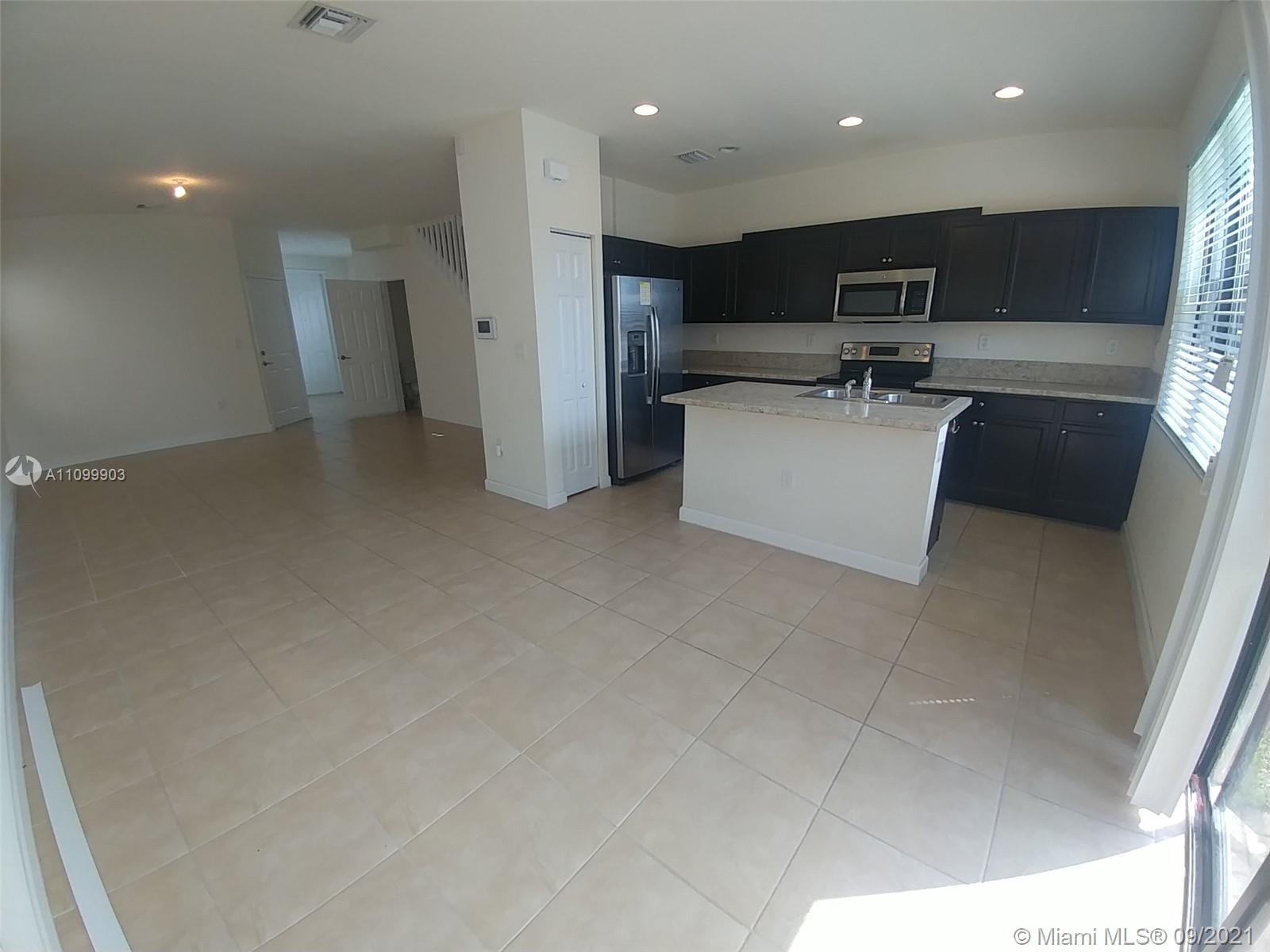 3778 Northeast 2nd Street Homestead, FL 33033 - Photo 6 of 15 a view of kitchen with stainless steel appliances a refrigerator and a sink