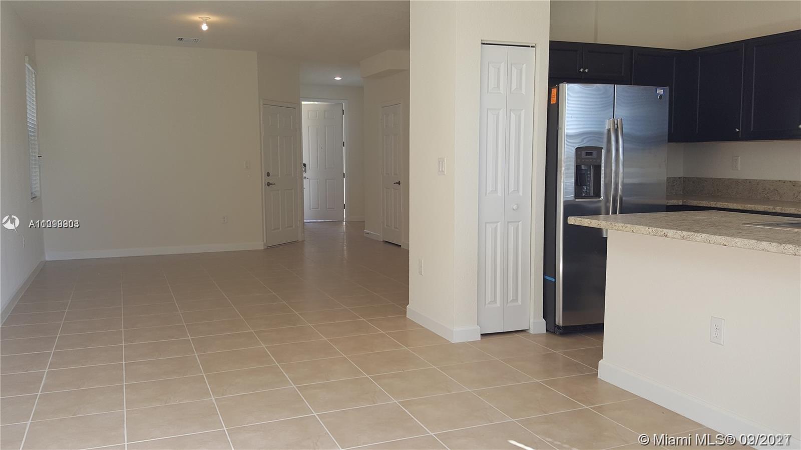 3778 Northeast 2nd Street Homestead, FL 33033 - Photo 8 of 15 a view of a kitchen with a sink and a refrigerator