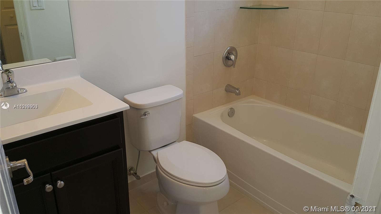 3778 Northeast 2nd Street Homestead, FL 33033 - Photo 10 of 15 a white toilet sitting next to a bathroom sink