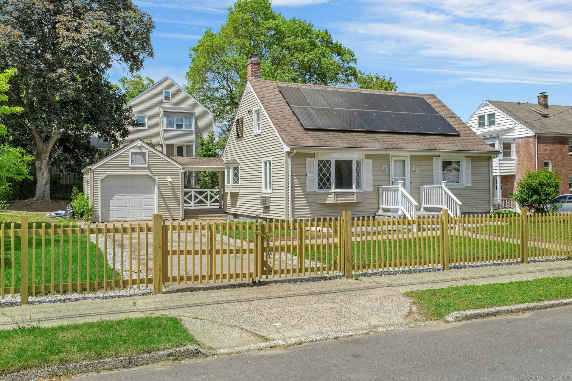 a front view of a house with a garden and plants