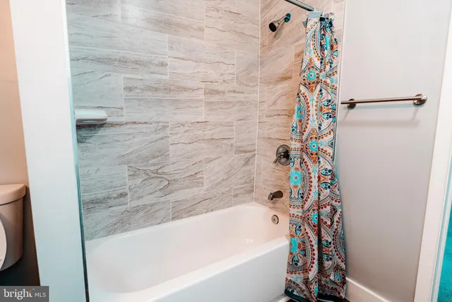 a bathroom with a bathtub and shower curtain