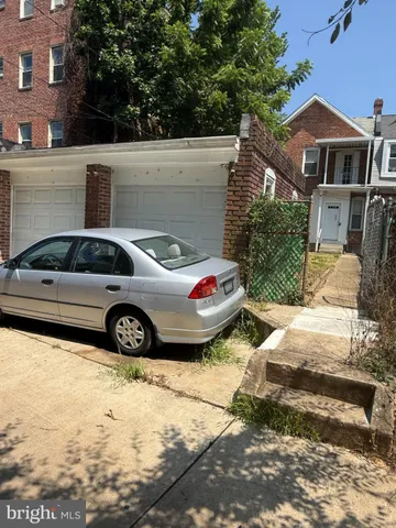 a view of a car parked in front of a house