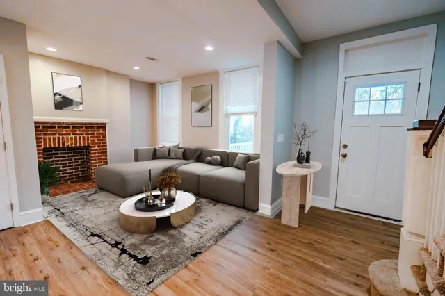 a living room with furniture and wooden floor
