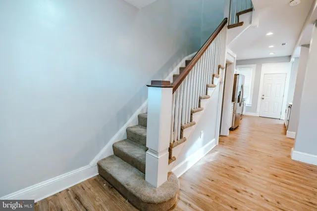 a view of entryway and hall with wooden floor