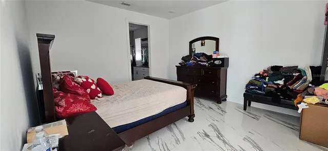 a bedroom with a bed and a dresser