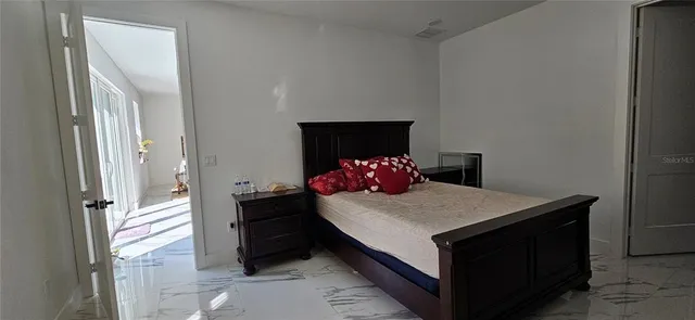 a bedroom with a bed and a dresser