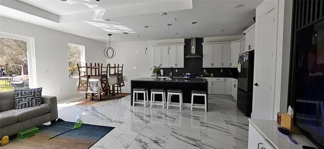 a living room with furniture a large window and a flat screen tv
