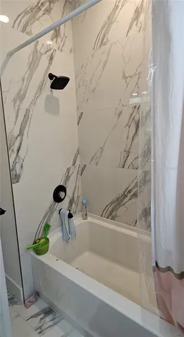 a bathroom with a bathtub and a shower