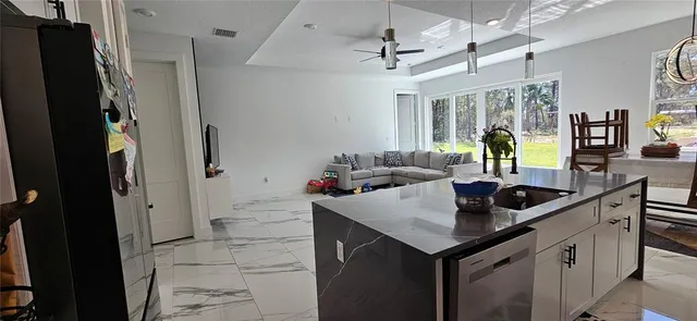 a kitchen with a sink a counter top space and stainless steel appliances