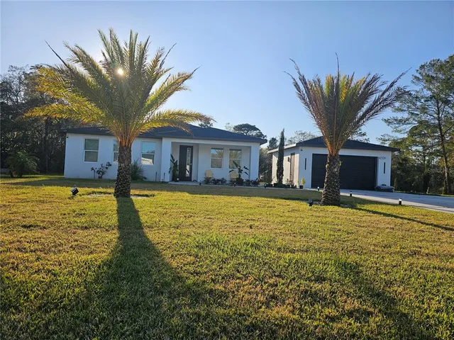 a house with a large pool in front of it